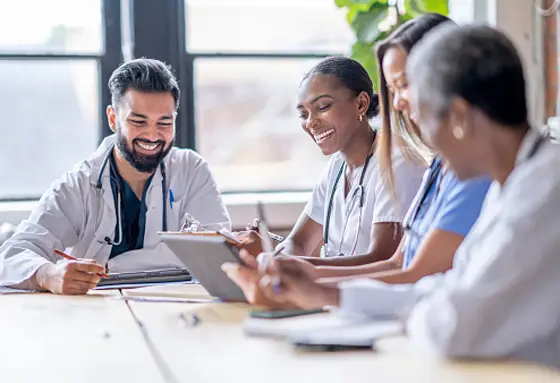 Diverse team of doctors and nurses collaborating in a hospital meeting