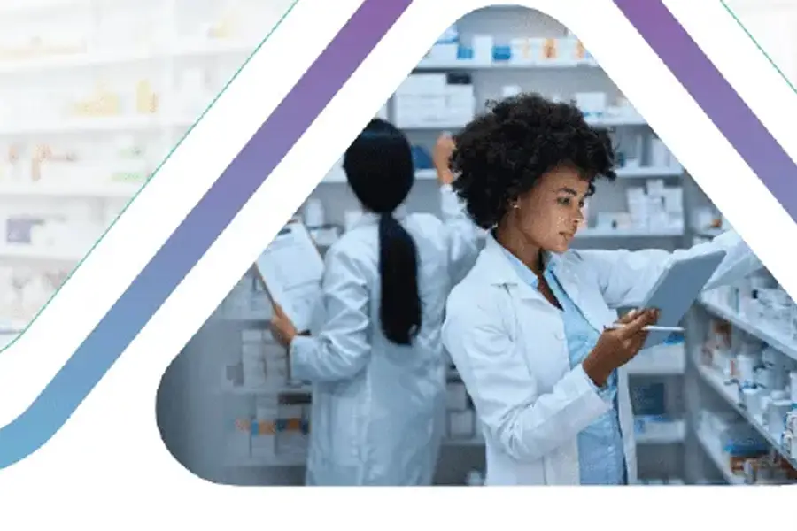 Pharmacists in white coats using tablet and clipboard while managing medicine inventory in pharmacy