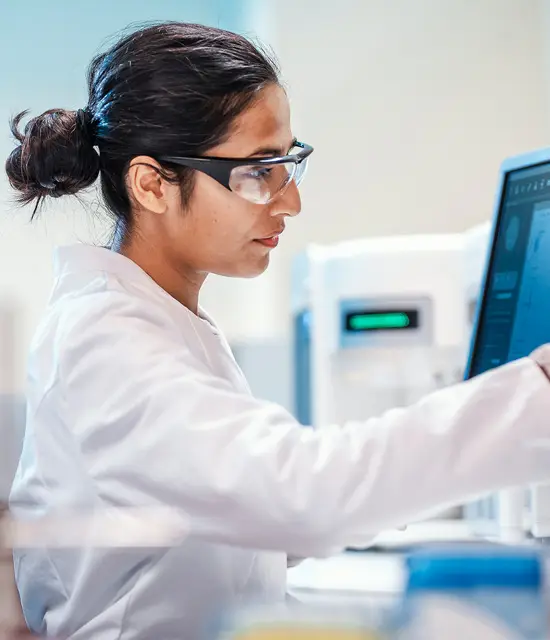 Female scientist working on computer in laboratory